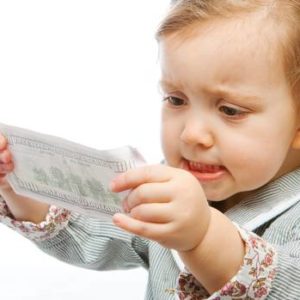 little girl using a 100 dollar bill