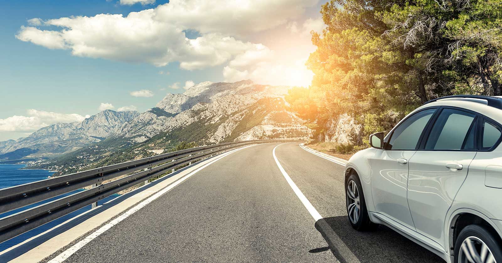 Car driving on the edge of a hill with beautiful view