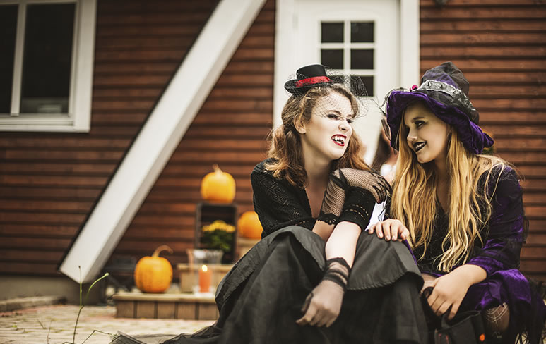 two girls dressed in Halloween costumes