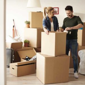 happy couple packing and moving to their dream home