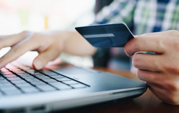 member checking transactions of UKRFCU Visa credit card on laptop