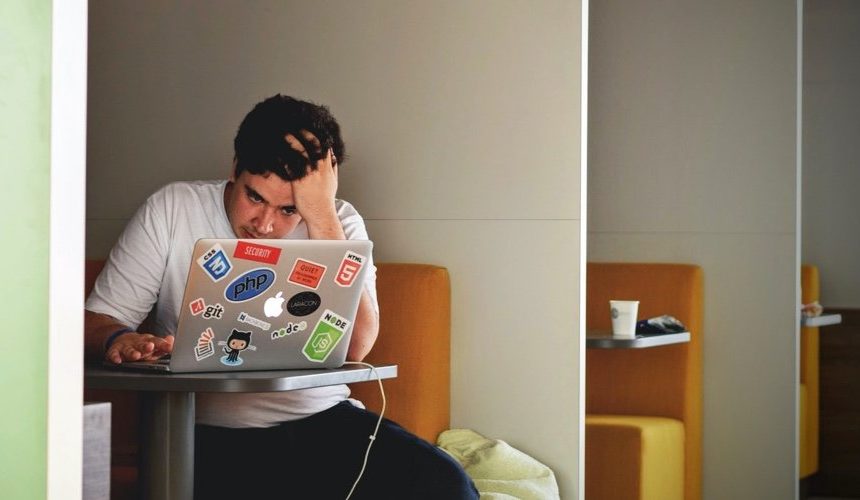 person frustrated looking at laptop