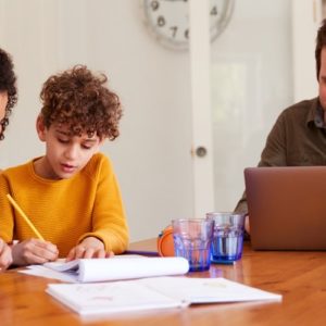 family working from home on dining room table