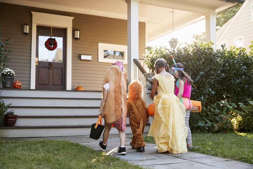 group of children trick of treating on halloween