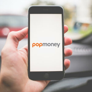 person holding phone, using popmoney to transfer money to a friend